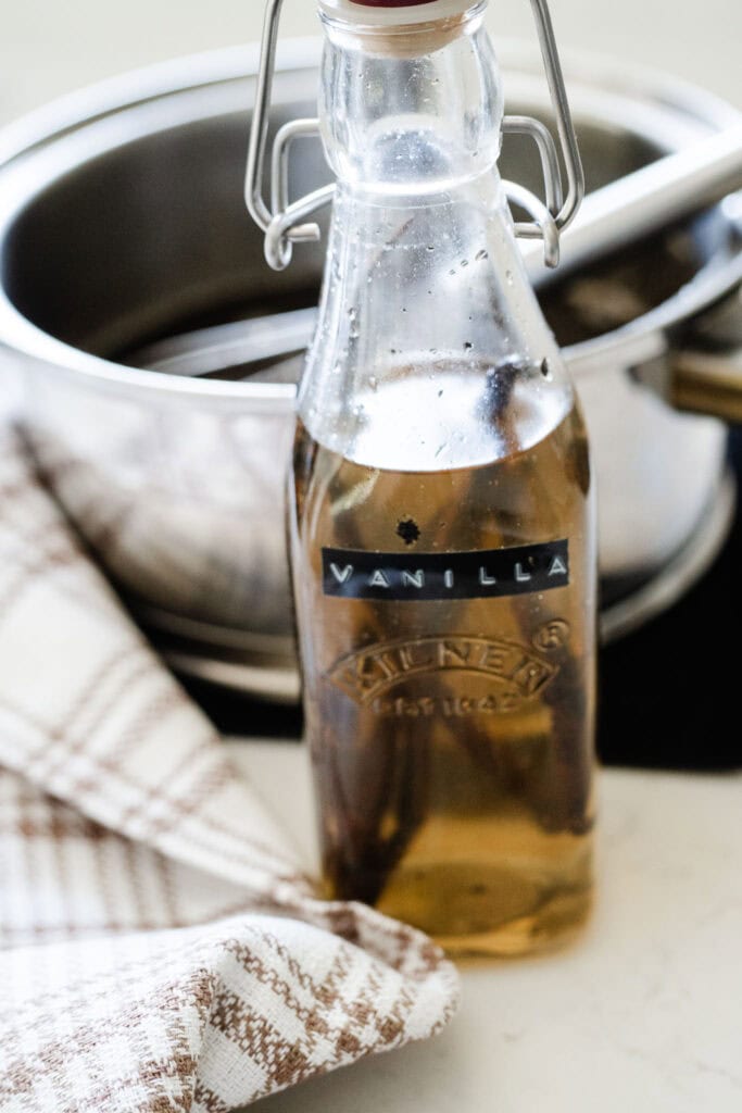 vanilla extract sitting in front of saucepan
