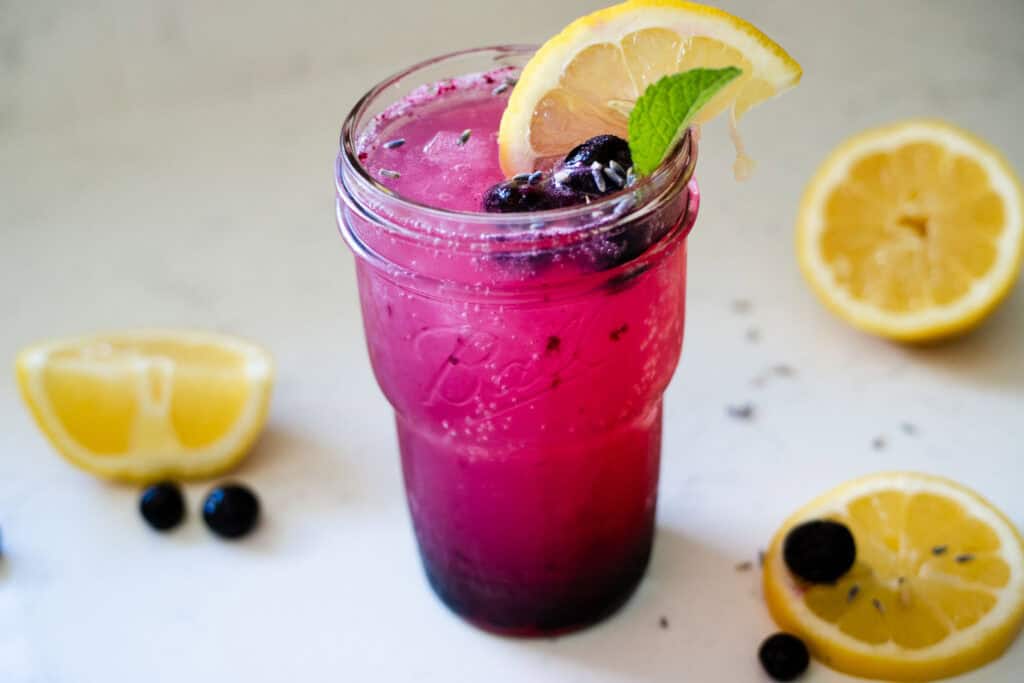 blueberry lavender lemonade served in a glass over ice