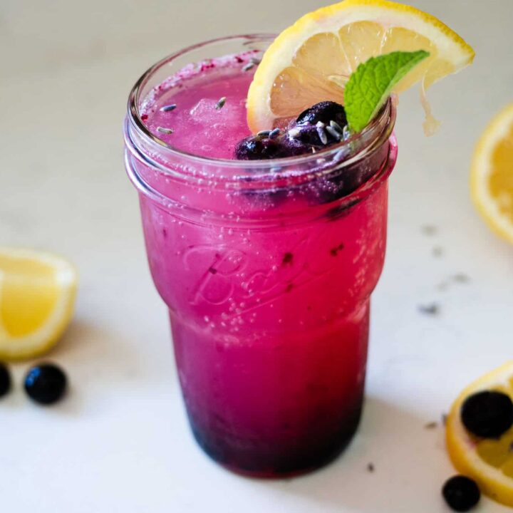 blueberry lavender lemonade served in a glass over ice