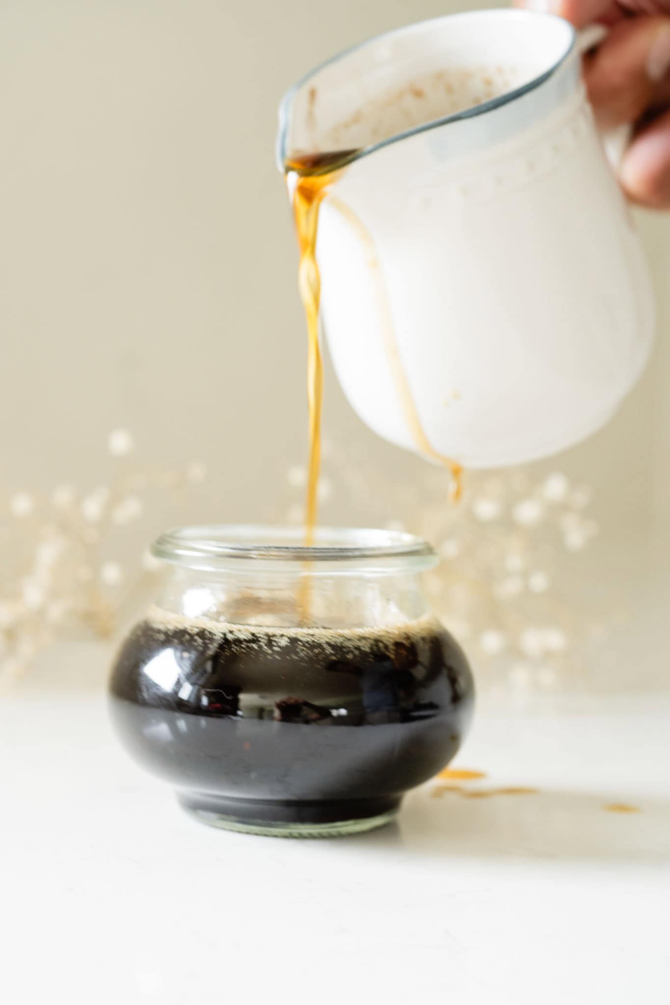 brown butter syrup being poured into a jar