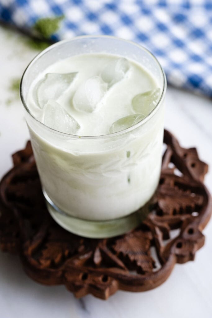 drink in a clear glass on a wooden stand