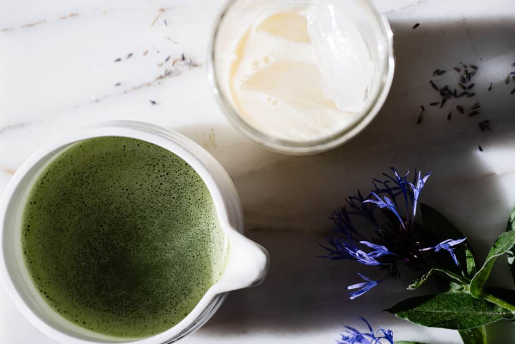 glass with ice and milk, ready for the matcha beside it