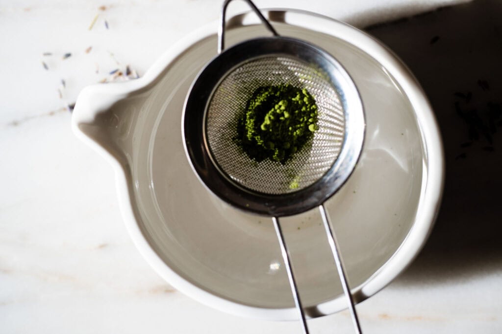 matcha being sifted through a sifter