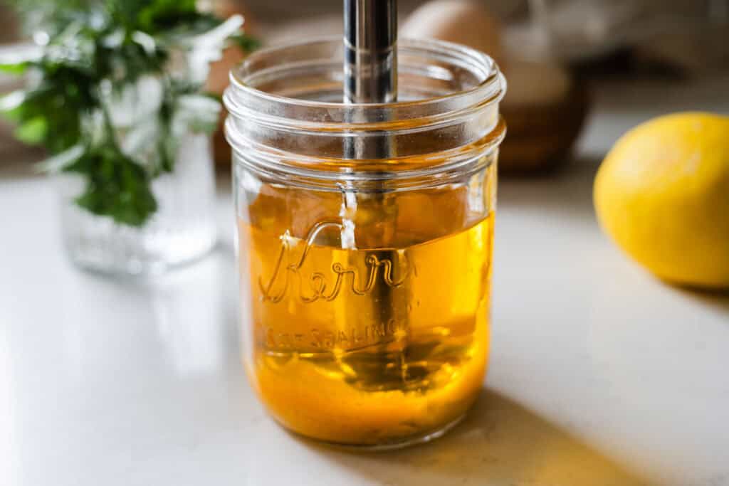 ghee added into a jar, ready to make mayo
