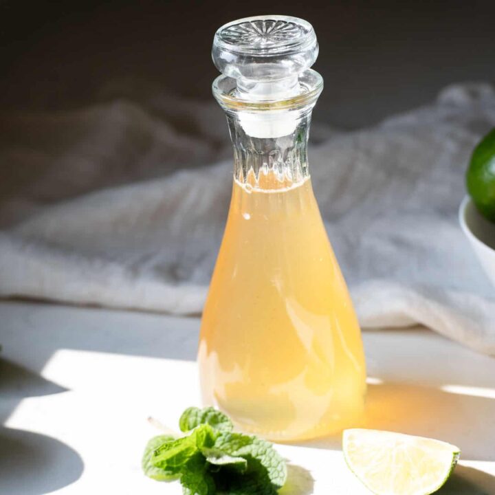 completed lime simple syrup in a glass bottle