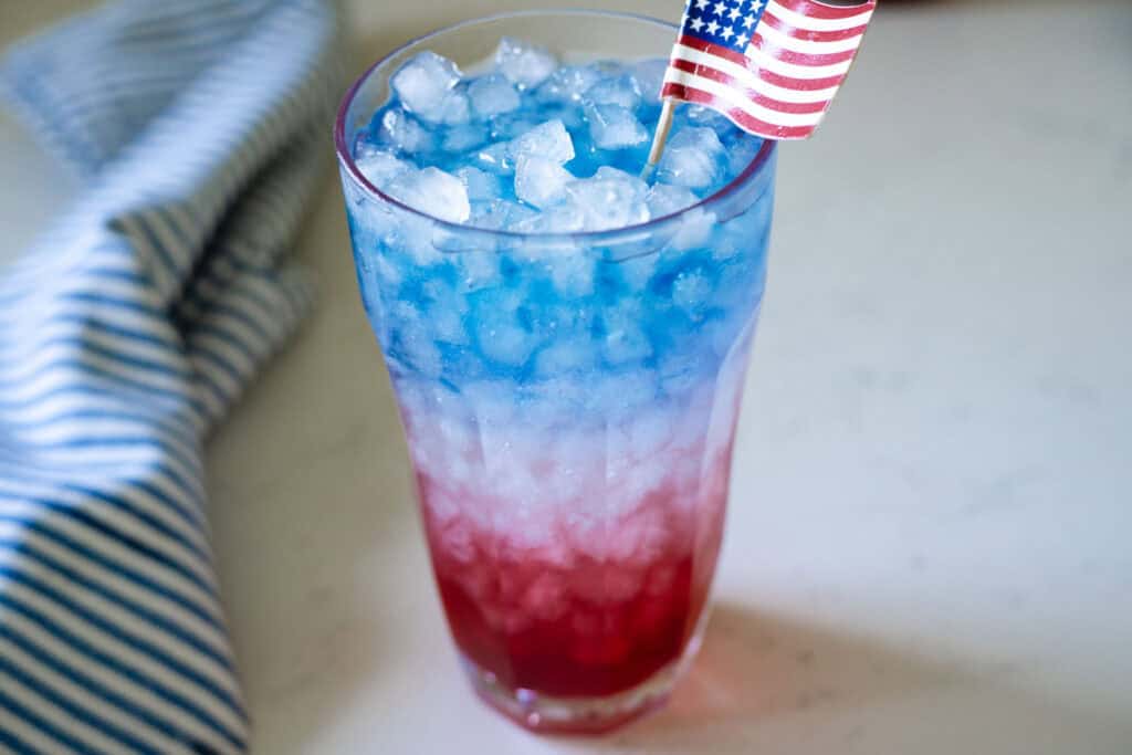red white and blue drink garnished with an American flag