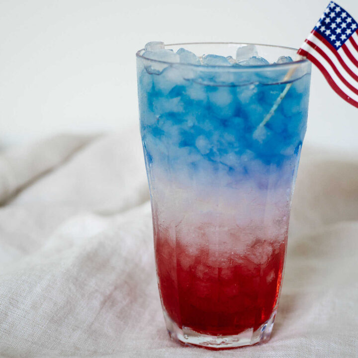 red white and blue drink in a cup with the american flag stuck in the top