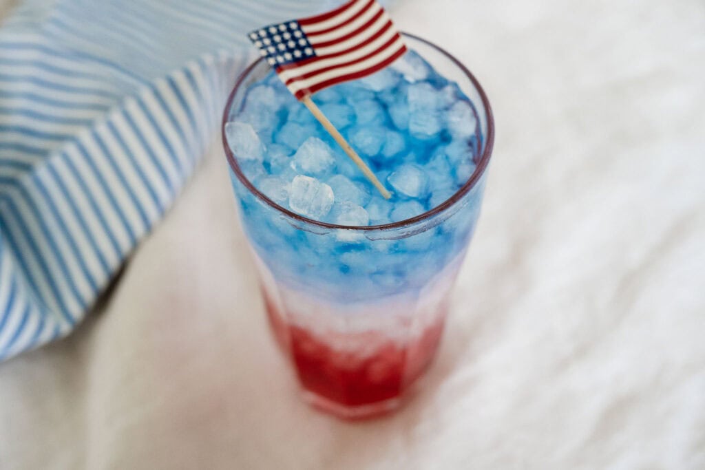 red white and blue drink in a cup with ice