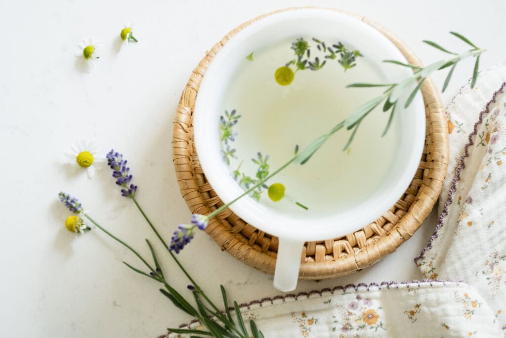 teacup with fresh lavender and chamomile flowers