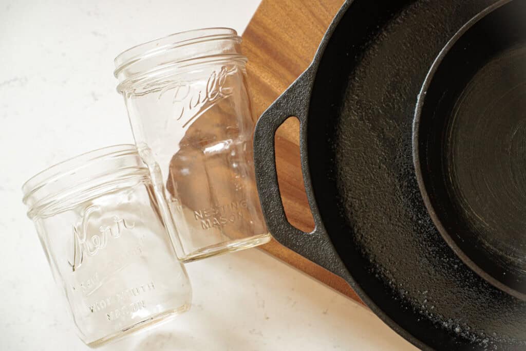 mason jars, wooden cutting board, and cast iron skillets
