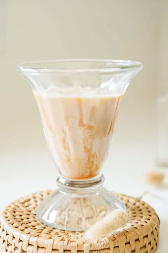 glass filled with ice, milk, and espresso