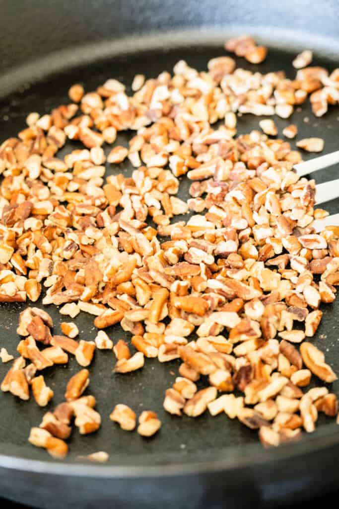 pecans toasting in a cast iron pan