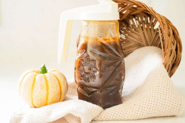 jar of syrup with a pumpkin and a basket