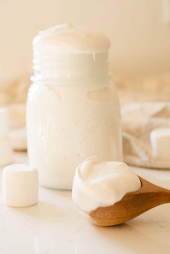 marshmallow fluff in a wooden scoop