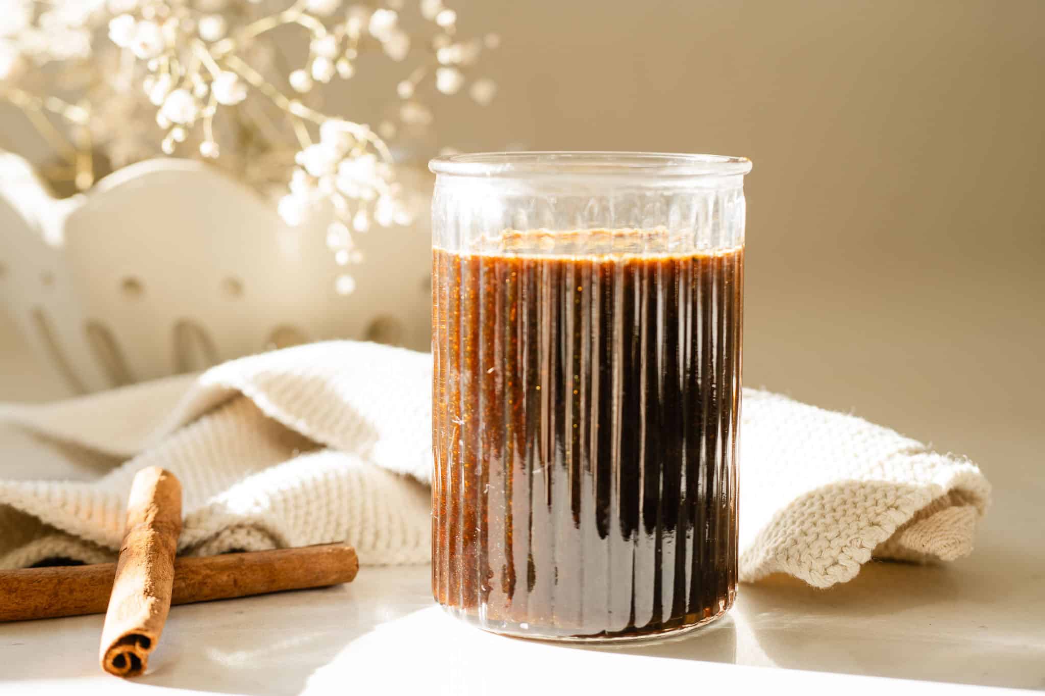 jar with syrup surrounded by spices