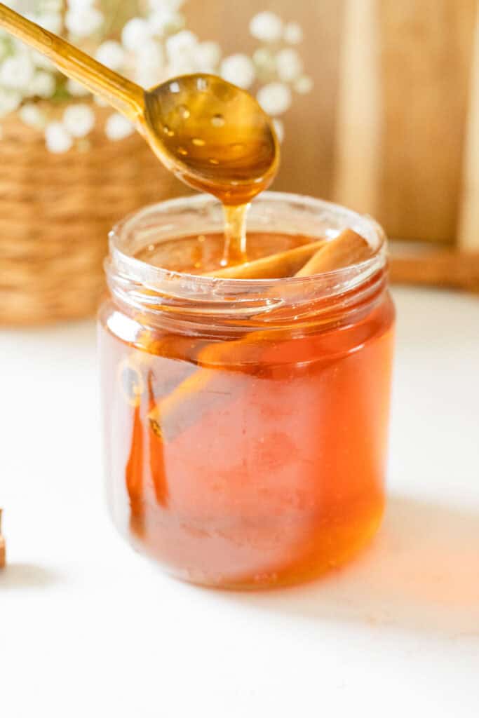 spoon drizzling cinnamon honey