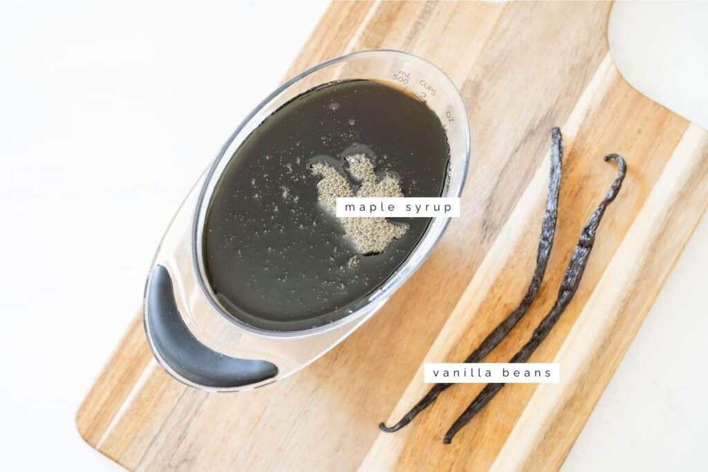maple syrup and vanilla beans on a cutting board