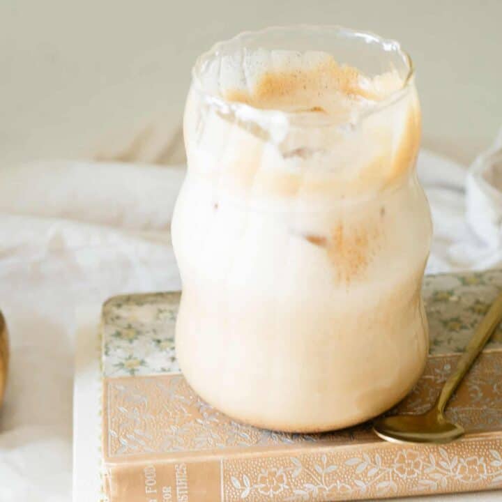iced latte on a stack of fall colored books